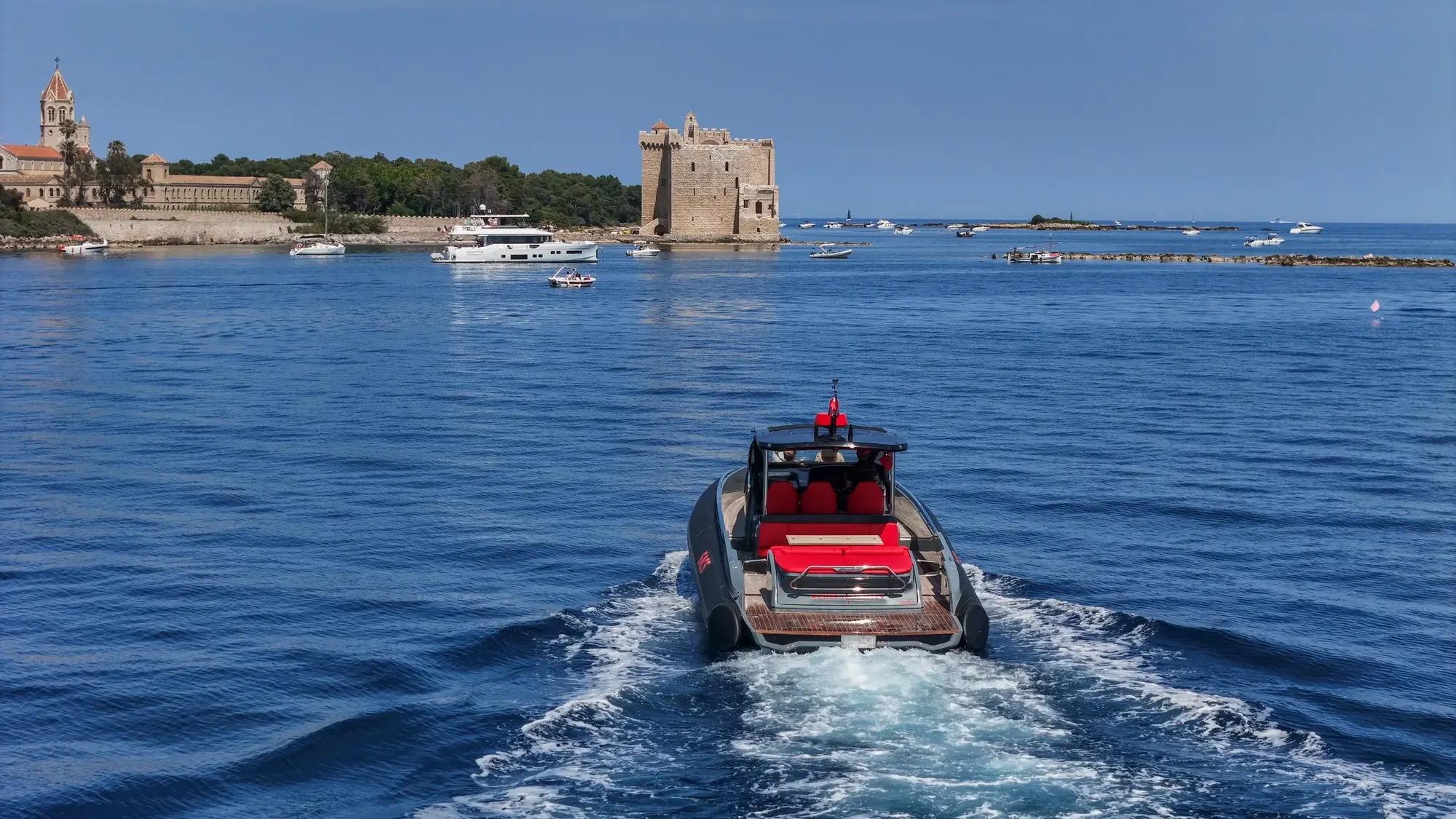 Queen of Hearts running out towards the Lérins, the monastery tower on the shore behind her.