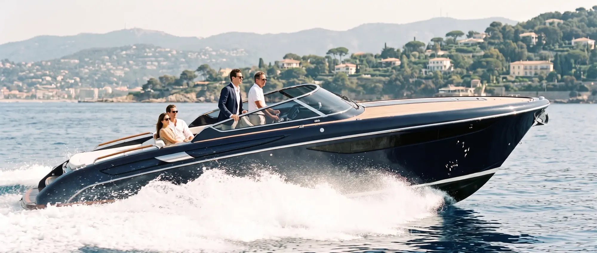 A day yacht underway along the coast, carrying guests to their destination.
