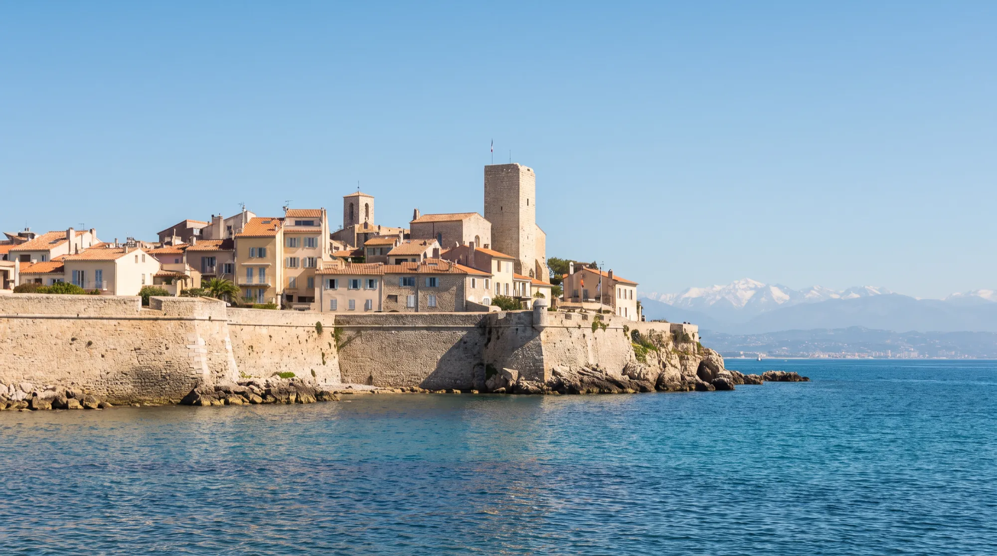 The stone ramparts and old town of Antibes seen from the sea.
